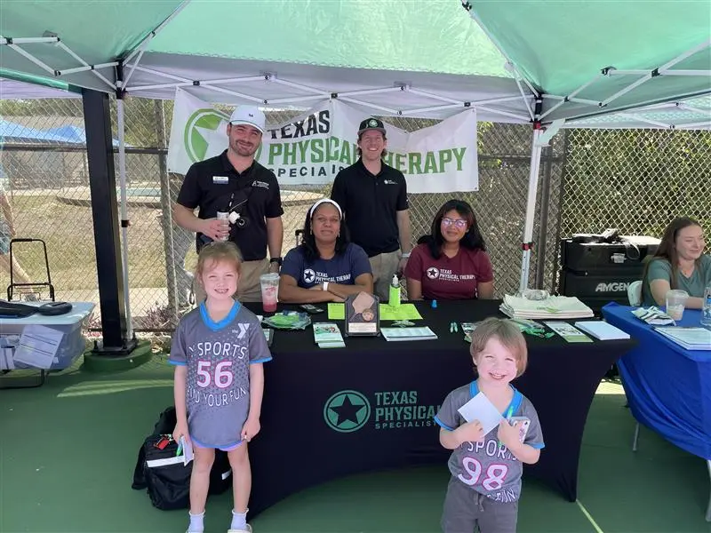 charity booth with volunteers representing TexPTS with kids