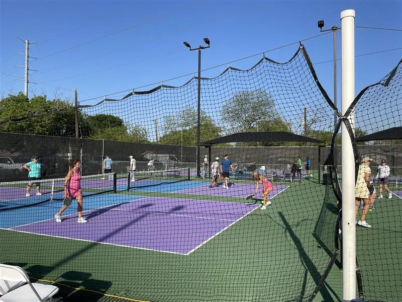 players on a pickle ball court during a charity tournament