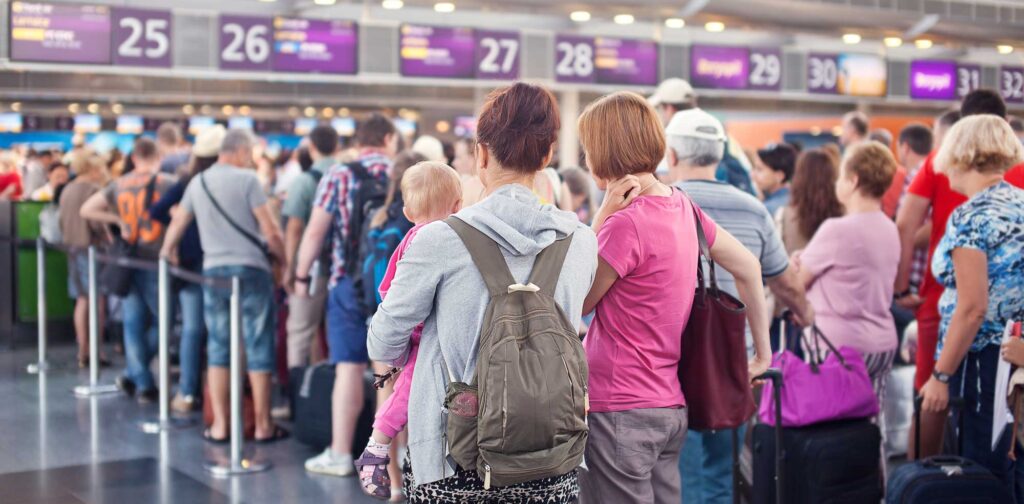passengers in an airport line holding their necks from travel stress.