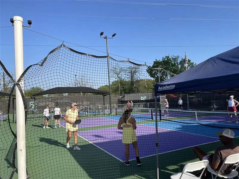 players on a pickle ball court during a charity tournament
