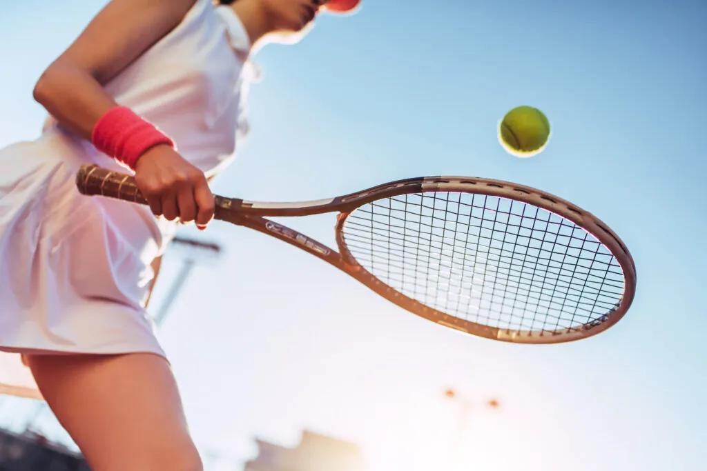 Sport young woman on tennis court. Female tennis player.