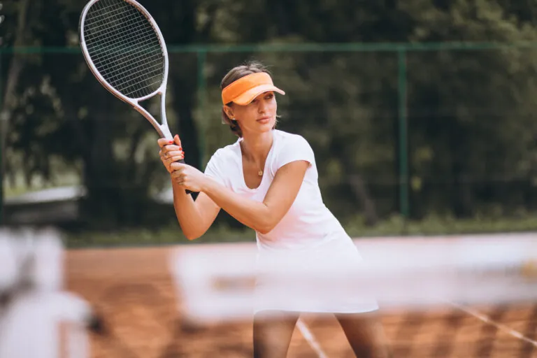 Young woman tennis player at the court
