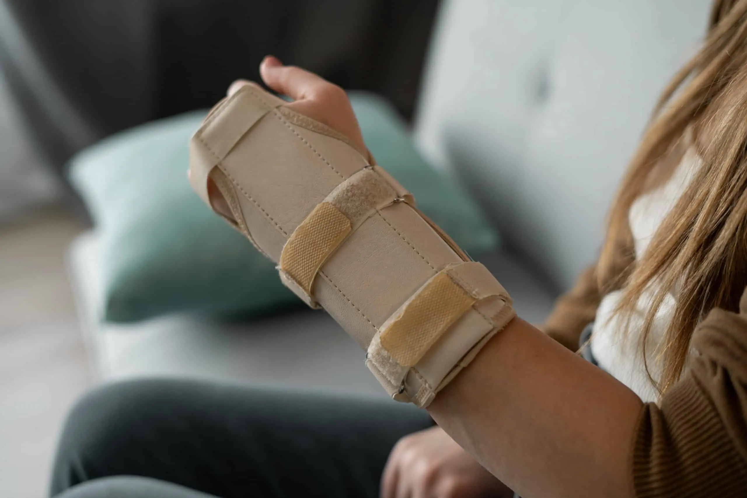 Hand injury. Broken wrist and arm with bandage or immobilizer. woman uses hand splints. Inflammation. Copy space