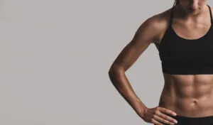 woman displaying her abs before or after a workout