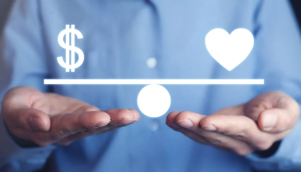 Man holding Money and Heart balance.