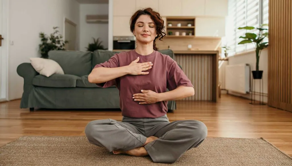 Woman focusing on breath for relaxation during a meditation session in her living room