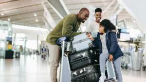a family at the airport with suitcases ready for vacation