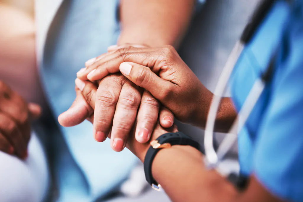 mpathy, trust and nurse holding hands with patient for help, consulting support and healthcare advice. Kindness, counseling and medical therapy in nursing home for hope, consultation and psychology